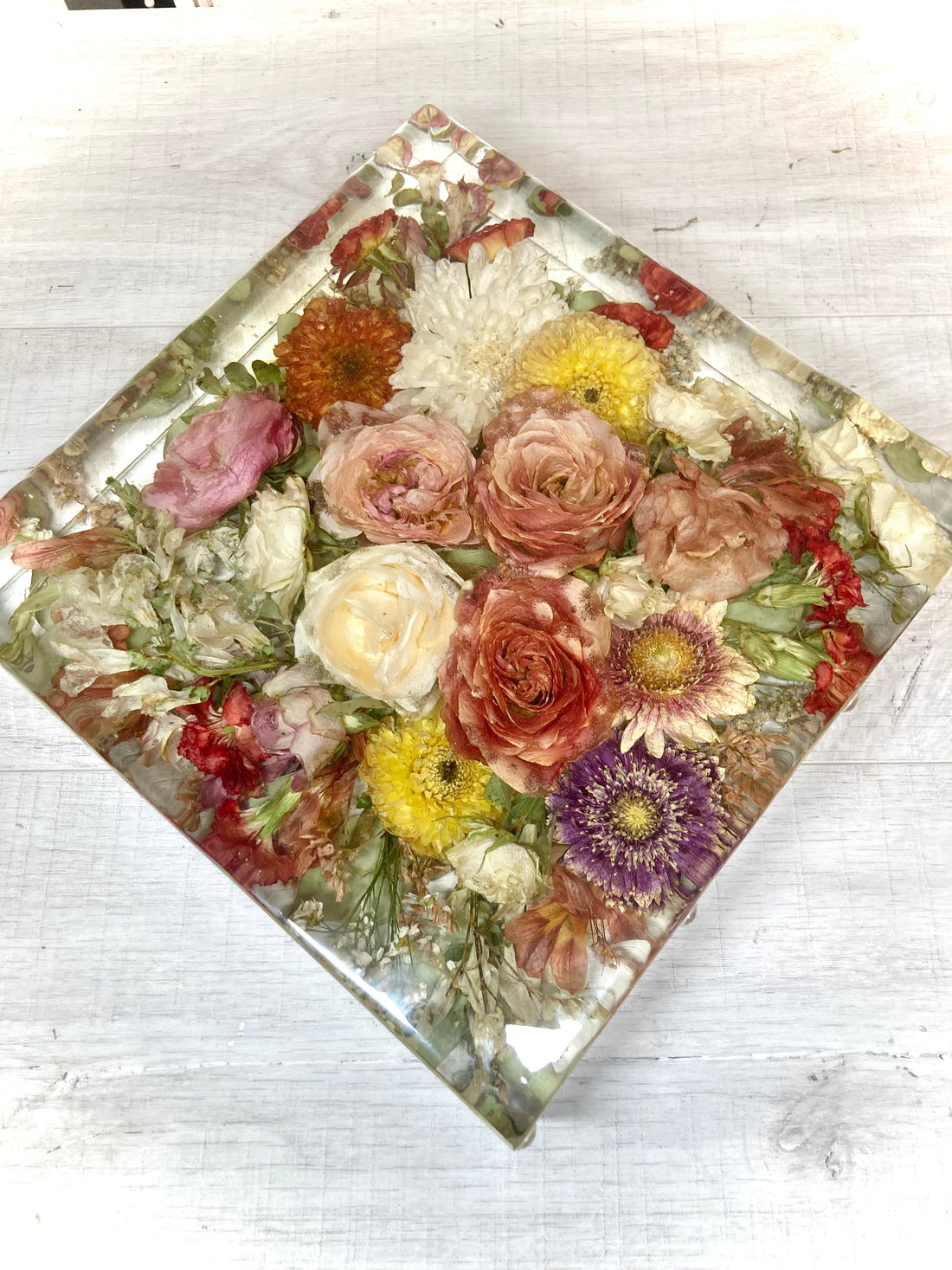 A beutiful 25cm resin display block containing a wedding bouquet