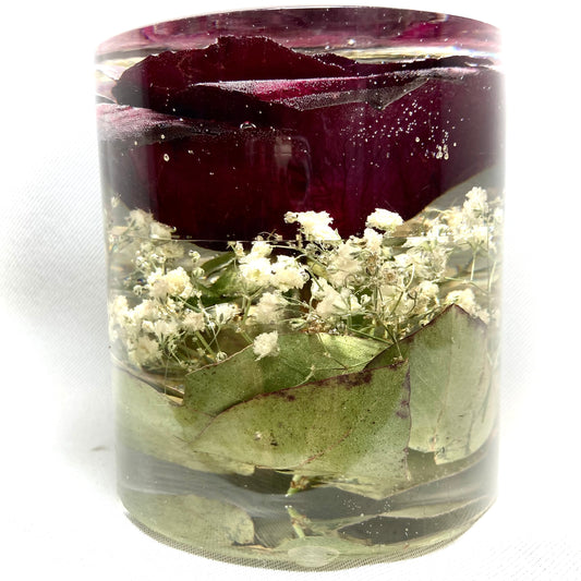 Cylinder containing a red rose, gypsophila and foliage