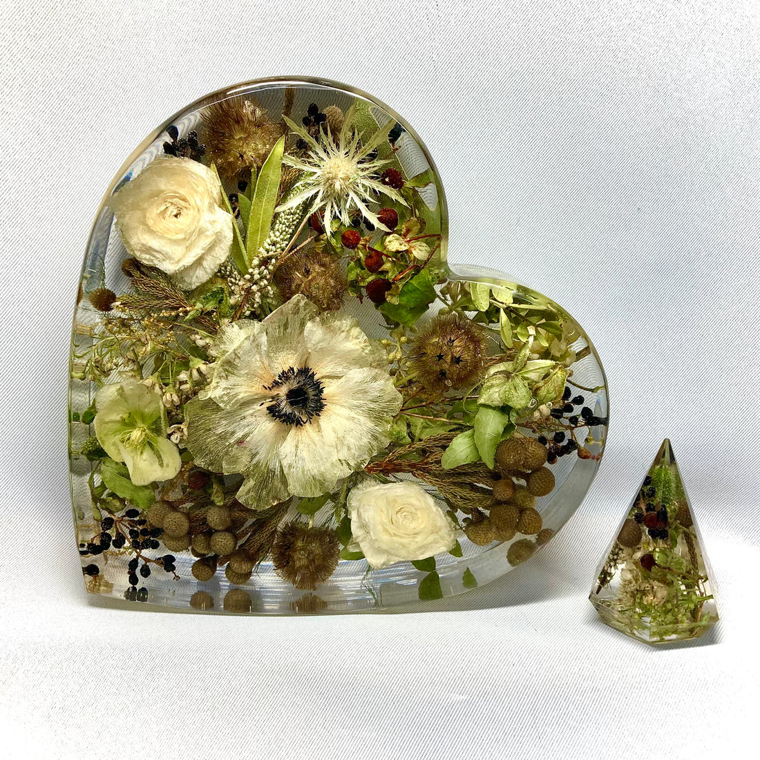 A stunning heart-shaped wedding flower preservation made with clear resin, preserving your special day's memories forever.