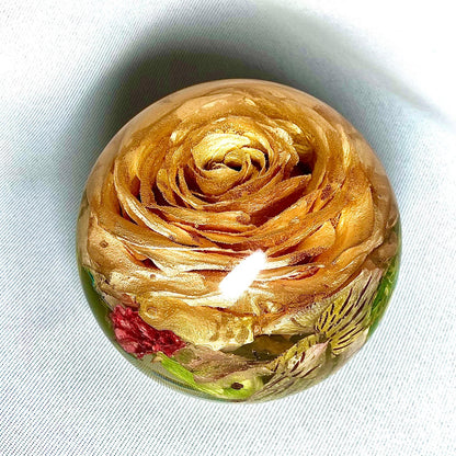 A decorative sphere paperweight made of resin, showcasing beautifully preserved wedding flowers, adding a unique and memorable touch to any space.