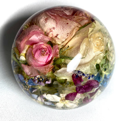 8cm flat bottom sphere containing a mixture of pink and white roses, blossoms and foliage