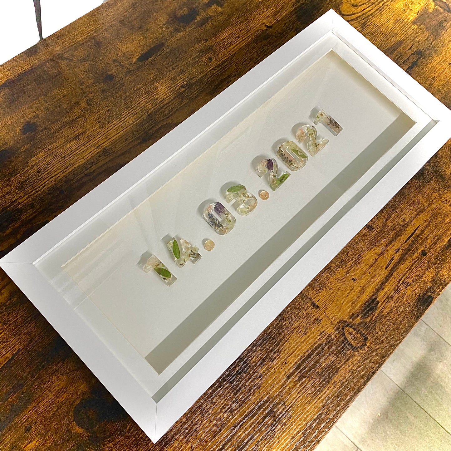 A beautiful and unique memory from your special day, this frame displays a stunning array of delicate wedding flower petals that have been carefully preserved to last a lifetime. The petals are arranged into your wedding date, creating a romantic and nostalgic piece that is sure to be cherished for years to come.